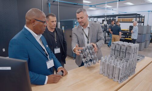 A3D Manufacturing team showing machined and 3D printed parts to visiting customers