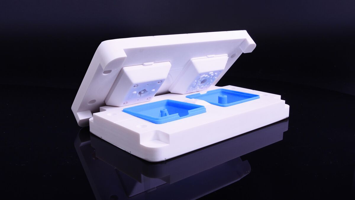 3D printed injection mold with blue cavity inserts made from Ultracur3D RG 3280 on a Stratasys Origin One P3 DLP printer