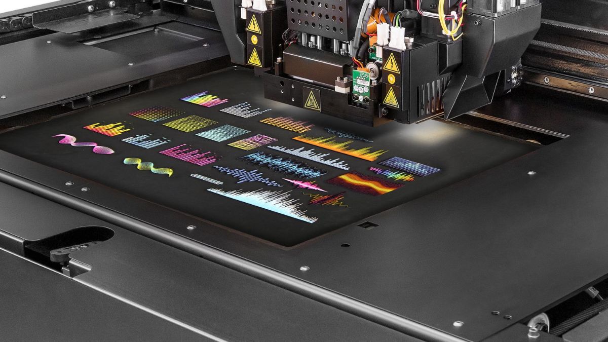 Close-up of the Stratasys J850 TechStyle print bed printing full-color designs directly onto fabric