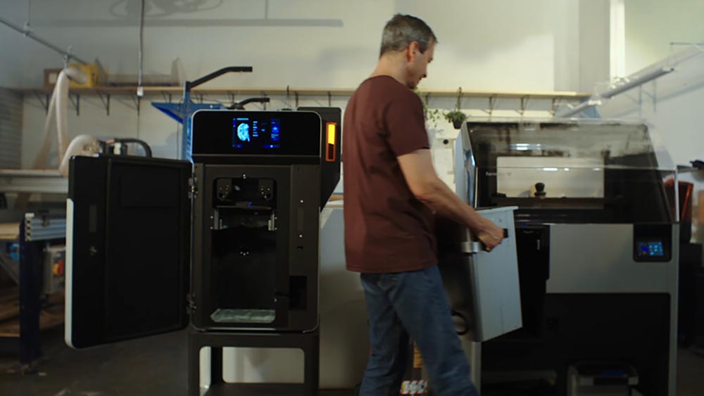 An operator running a job on the Formlabs Fuse1+ 30W 3D printer 