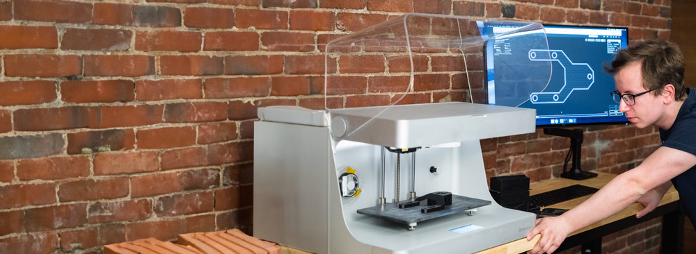 An operator running the Markforged Mark Two 3D printer 