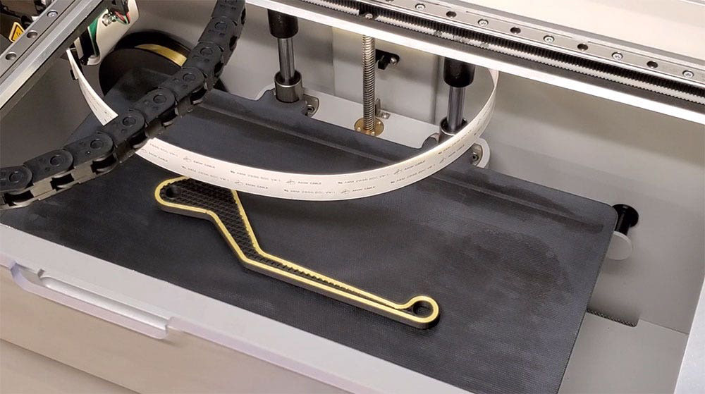 A Markforged part being printed with continuous fiber reinforcement 