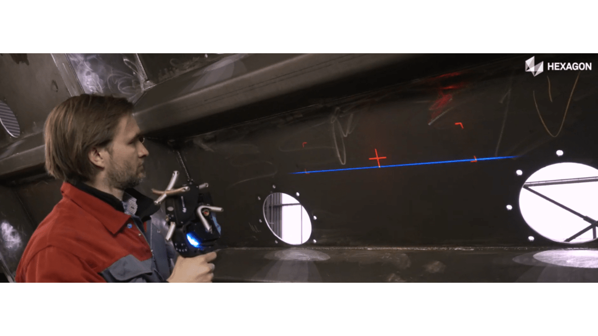 Man scanning large metal forming for inspection with Hexagon AS1X laser 3D scanner