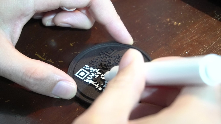 Adding color to a 3D printed QR code part