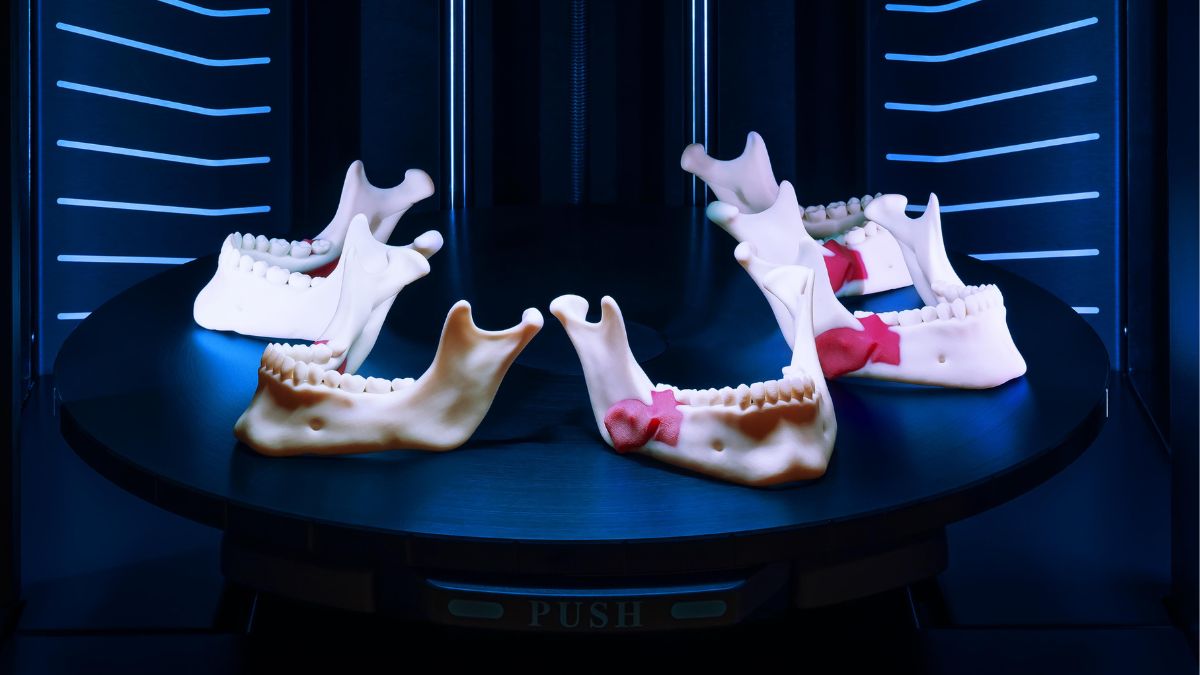 Jaw models displayed on the build tray inside a Stratasys J5 MediJet printer.