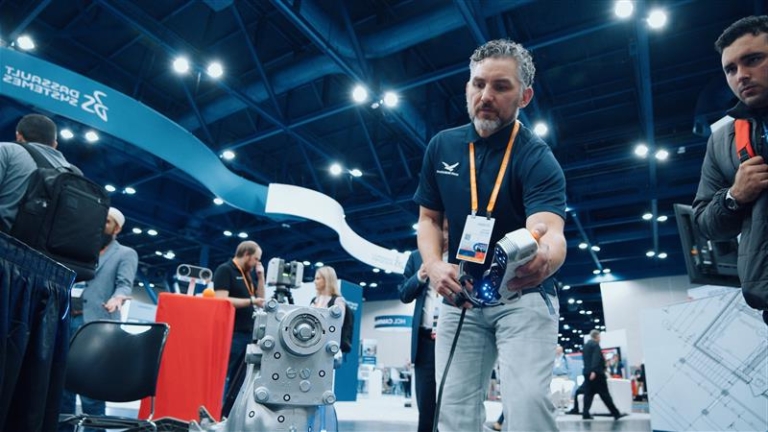 HRS employee showcasing 3D scanners at a conference