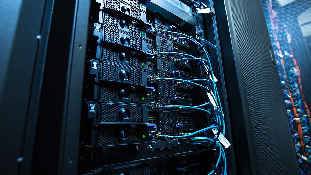 Close-up of server blades connected by blue network cables in a rack