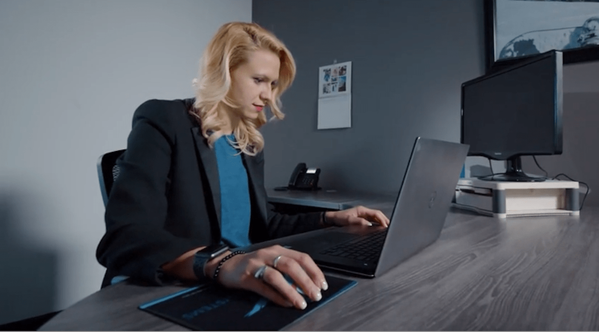 Engineer Nikki Stakic sits at a desk using a laptop in an office setting