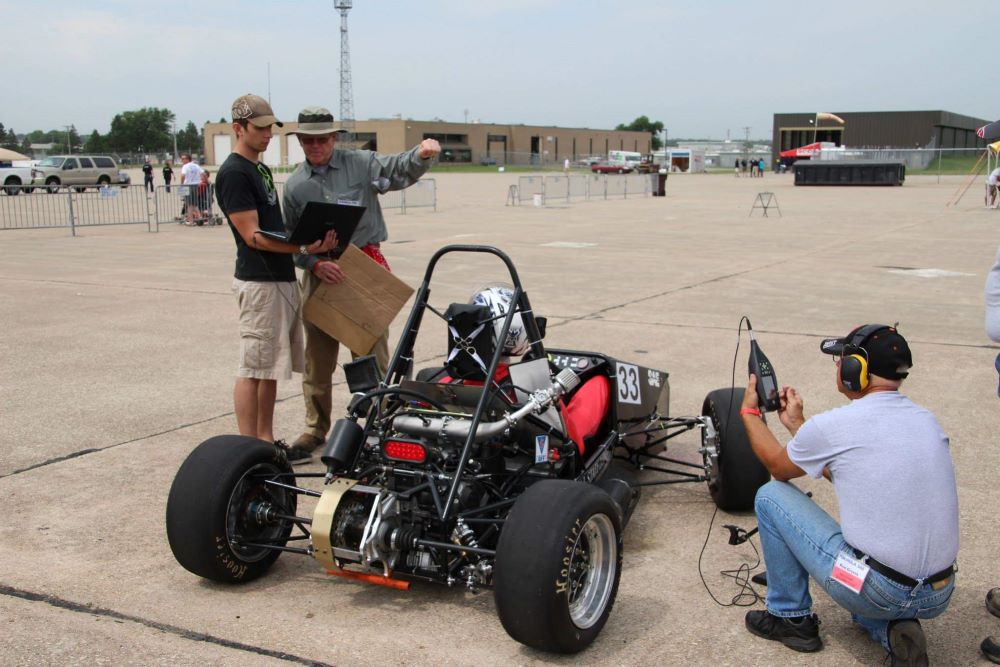 Taylor Hoff, Applications Engineer at Hawk Ridge Systems working on a formula SAE race car as part of a college project. 